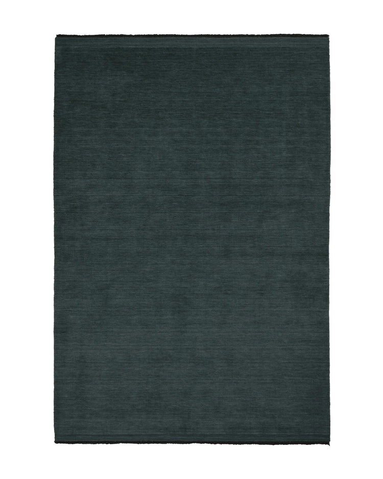 Silvio Dusk rug in deep muted blue with micro fringe border detail, sustainable hand-woven design by Weave Home