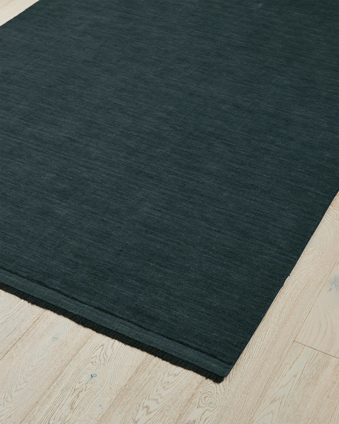 Silvio Dusk rug in deep muted blue, 3m x 4m, with micro fringe border detail and hand-woven texture by Weave Home