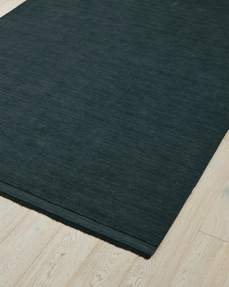Silvio Dusk rug in deep muted blue, 3m x 4m, with micro fringe border detail and hand-woven texture by Weave Home