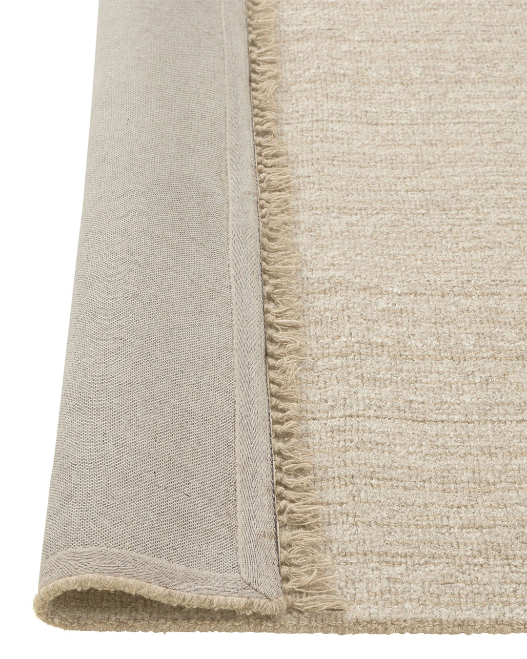Puglia Hemp textured rug detail, showing chunky woven polyester-wool blend with fringe edge on beige base by Weave Home