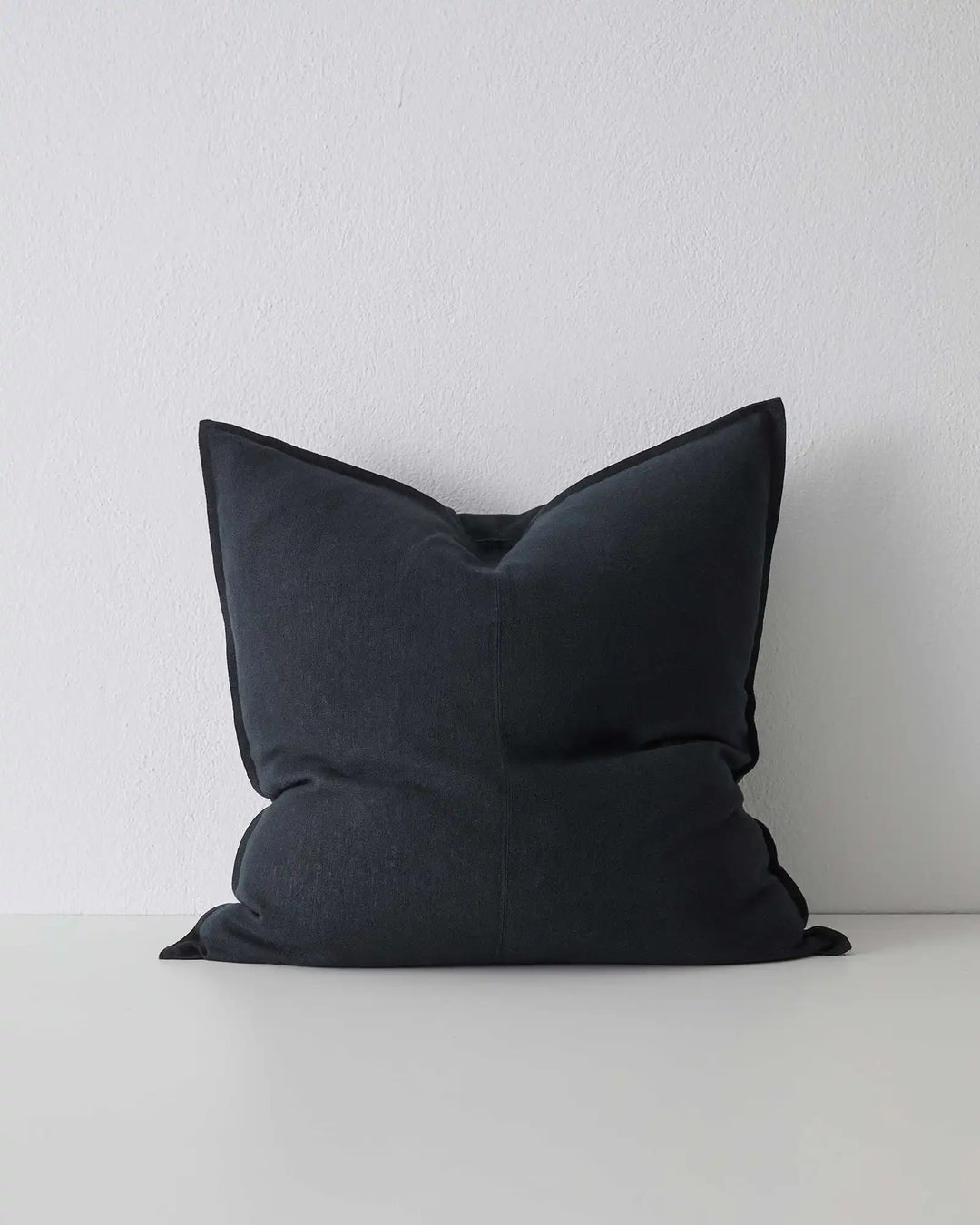 Como Shadow 60x60 linen cushion in classic black, stonewashed European linen with soft envelope closure, front view by Weave Home