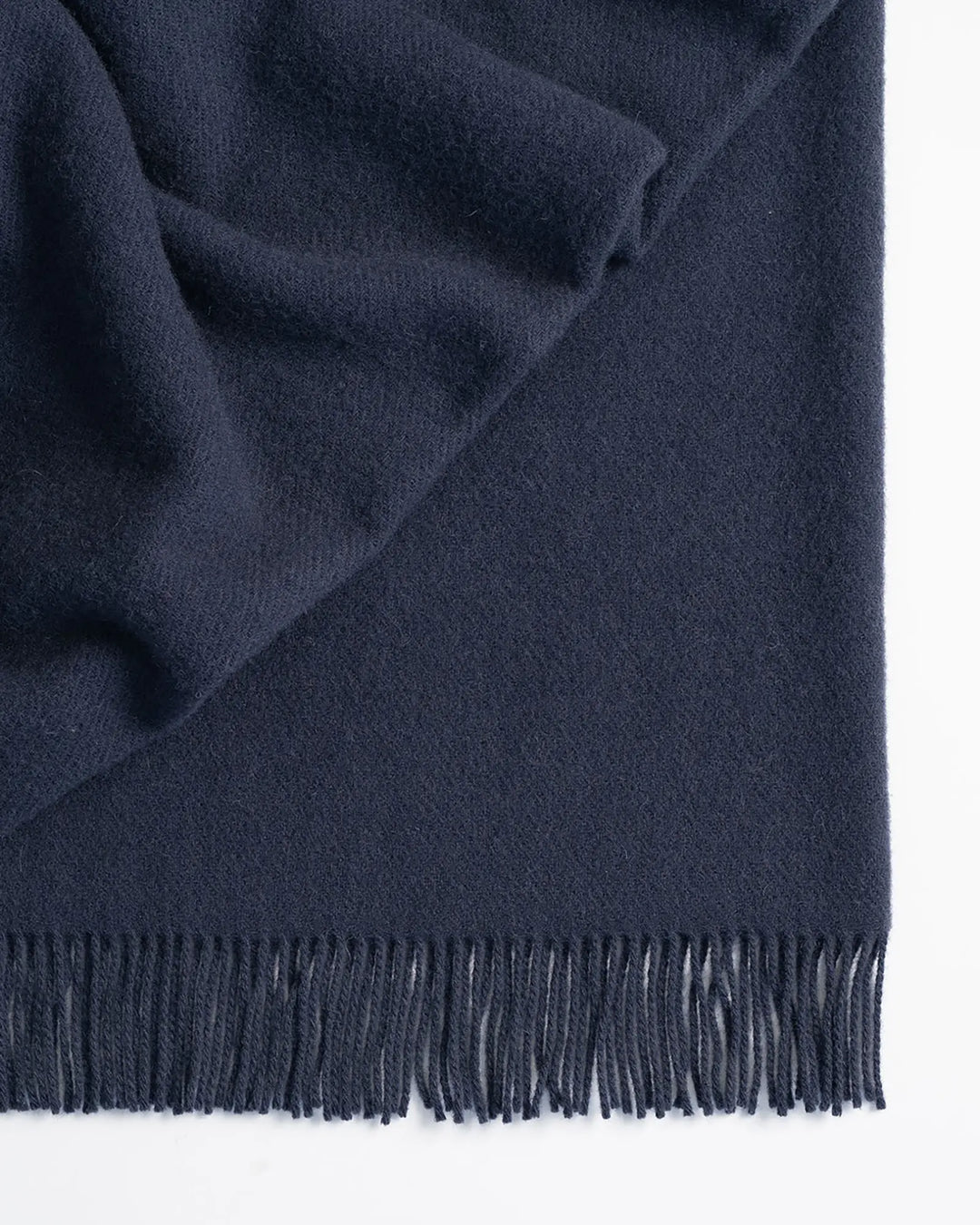 Nevis Navy throw detail, showing soft lambswool texture and tassel border edge by Weave Home
