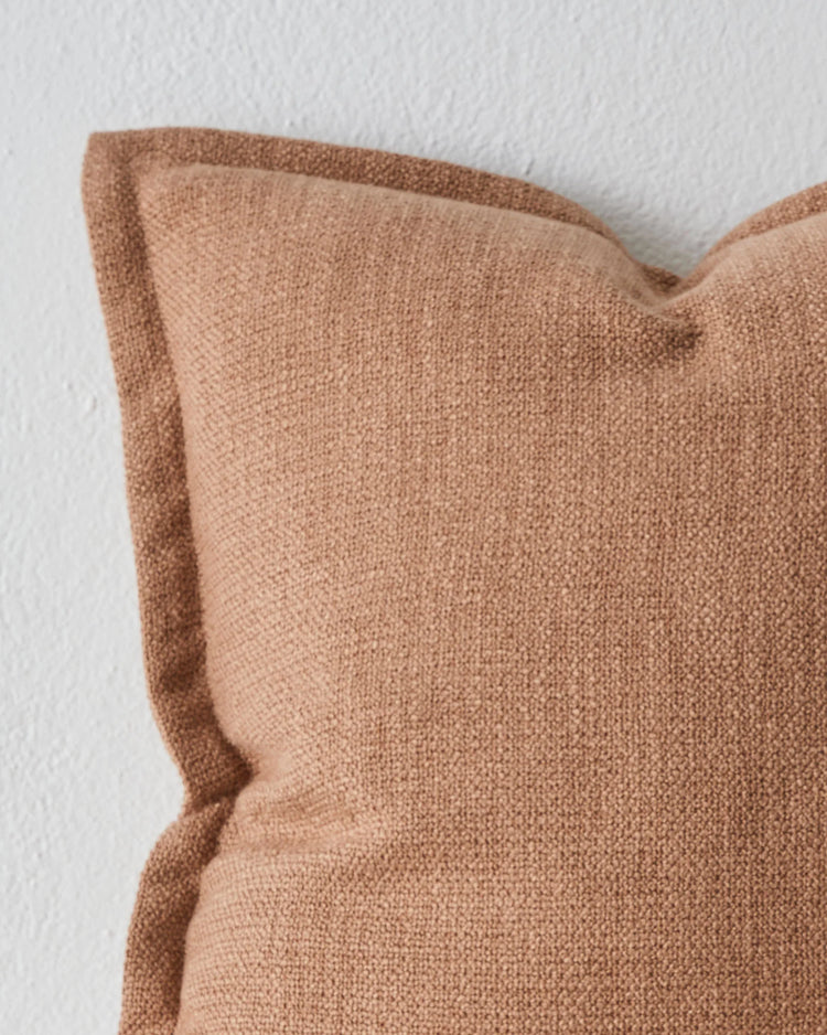 Figlio Terra 50x50 cushion close-up, warm terracotta polyester with chunky woven texture and tailored seam detail by Weave Home