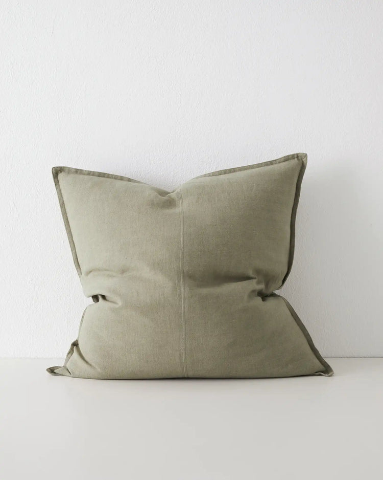 Como Caper 60x60 linen cushion in soft muted green with tailored piping edge detail by Weave Home