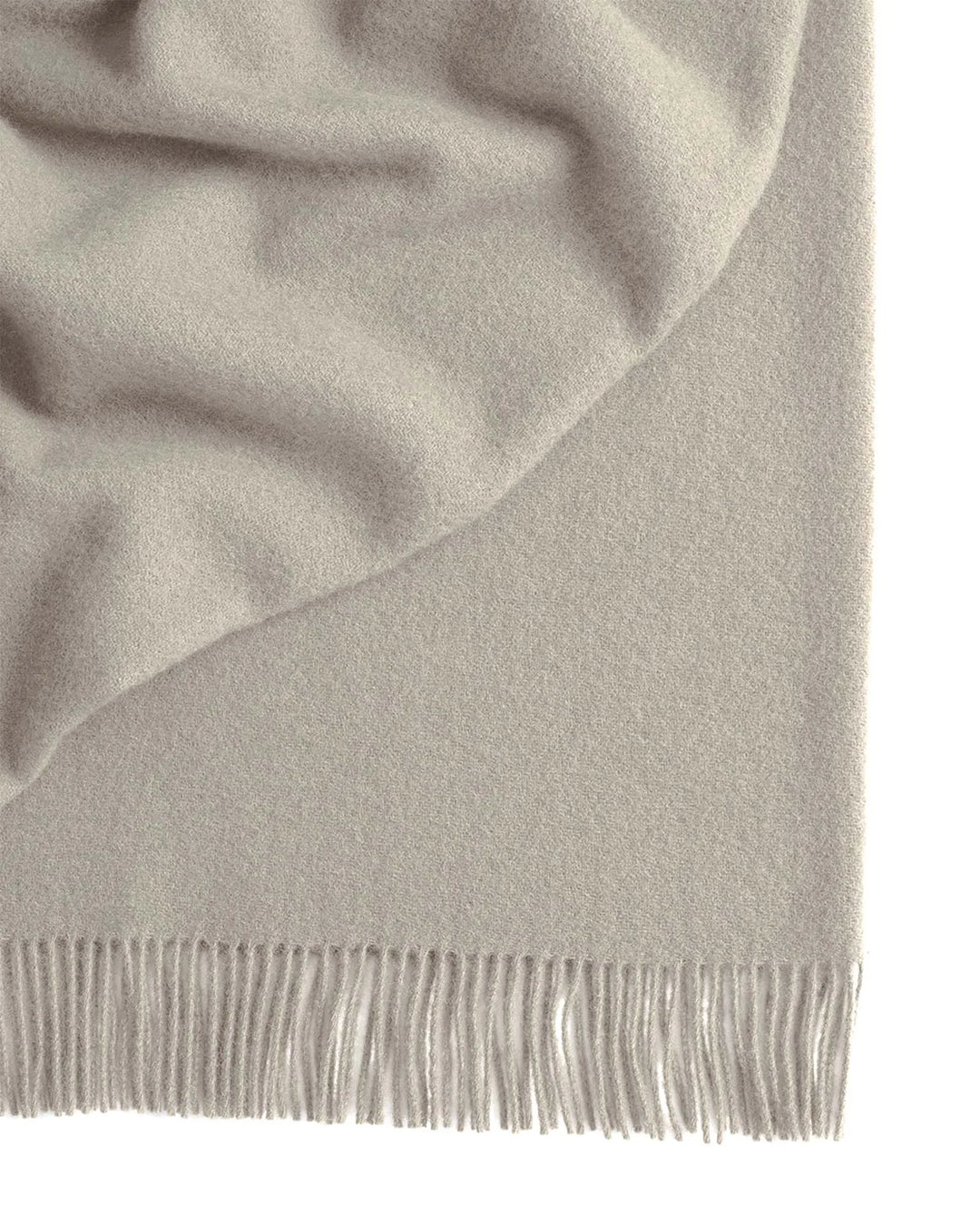 Nevis Limestone throw in muted grey wool, close-up detail of tassel border fringe by Weave Home