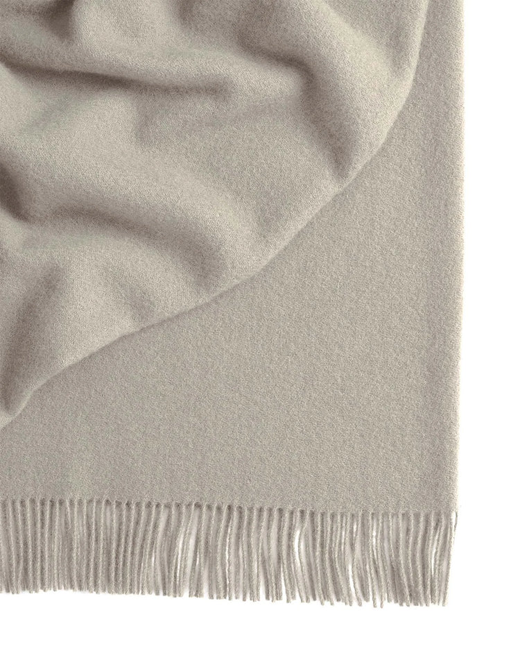 Nevis Limestone throw in muted grey wool, close-up detail of tassel border fringe by Weave Home