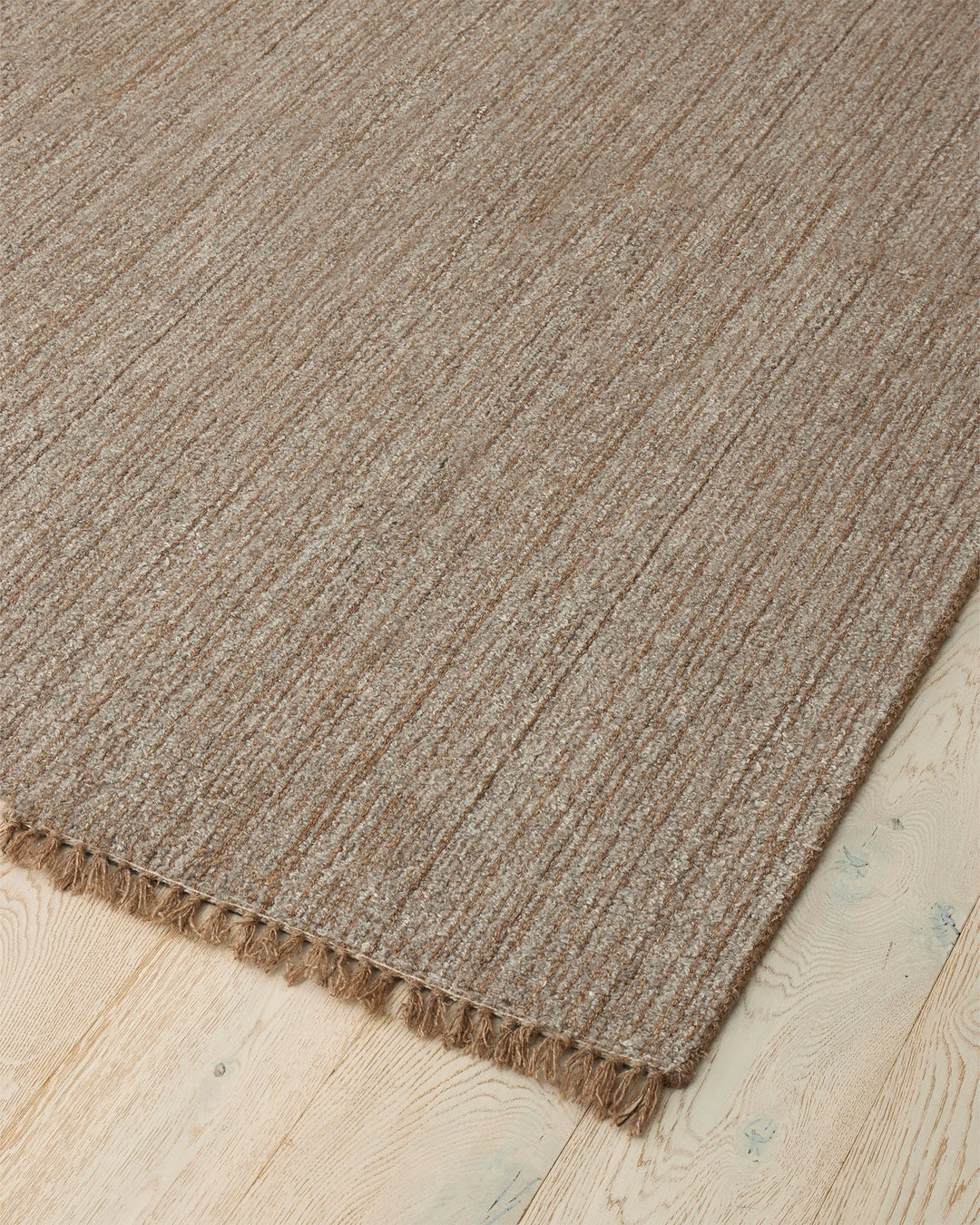 Puglia Taupe rug corner detail showing chunky woven texture with fringe edge, polyester wool blend by Weave Home