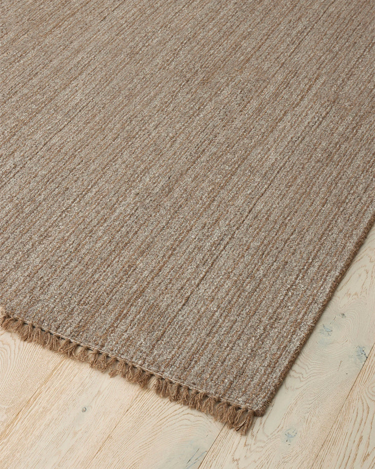 Puglia Taupe rug corner detail showing chunky woven texture with fringe edge, polyester wool blend by Weave Home