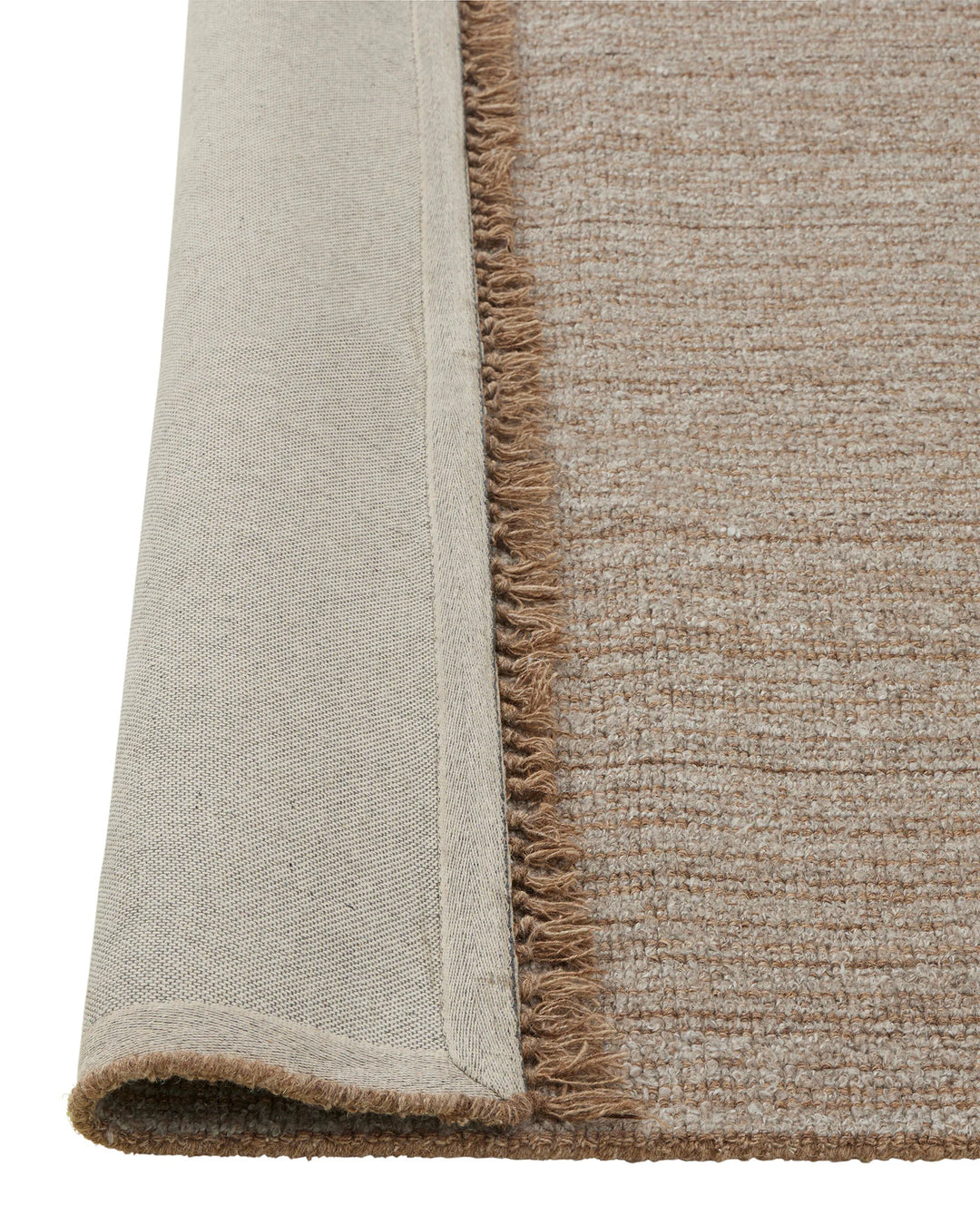Puglia Taupe rug detail showing chunky woven texture with fringe edge and cream-bound backing by Weave Home