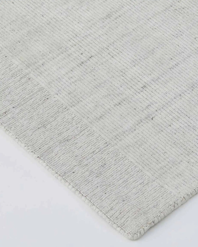 Travertine Marble rug detail showing hand-woven viscose blend texture with fringe edge, white by Weave Home