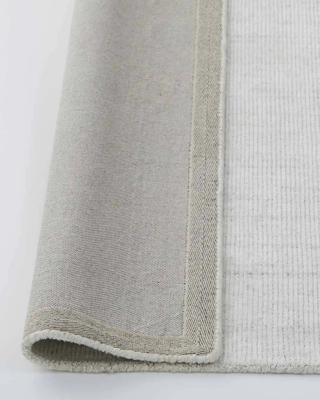 Travertine Marble rug close-up of woven edge and cotton backing detail, 200x300cm viscose blend by Weave Home