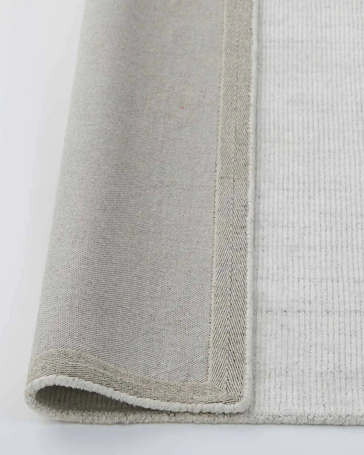Travertine Marble rug close-up of woven edge and cotton backing detail, 200x300cm viscose blend by Weave Home