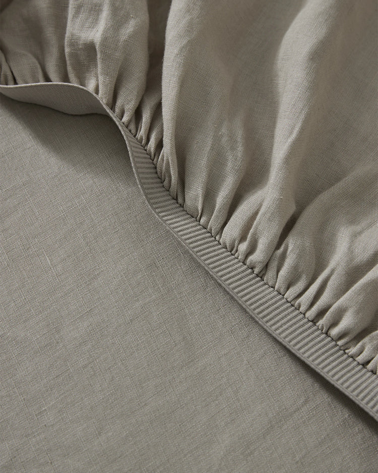 Ravello Fitted Sheet in Pebble, detail view of elastic-gathered corner with thick binding seam, European linen by Weave Home
