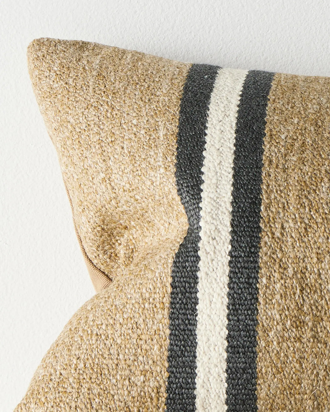 Mila Desert lumbar cushion close-up, wool-linen blend in sand with charcoal and cream stripe detail by Weave Home