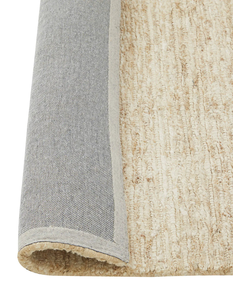 Bastian Macadamia jute rug detail view showing looped and cut linear texture weave with grey binding, by Weave Home