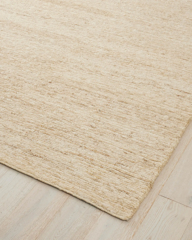 Bastian Macadamia jute rug corner detail, showing textured linear weave in creamy neutral tone by Weave Home