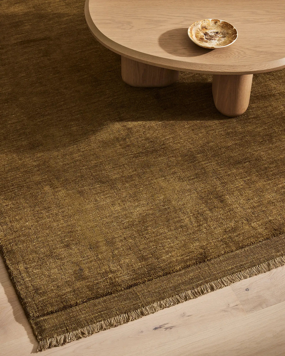 Silvio Oakmoss rug in rich olive, hand-woven with micro fringe border detail, sustainable styling by Weave Home