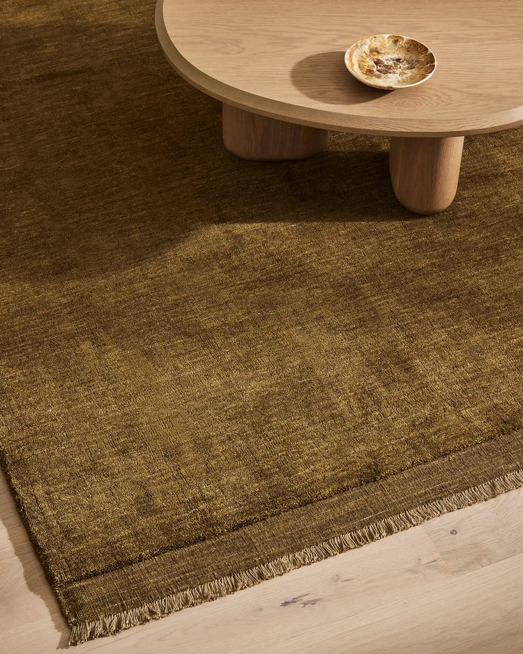 Silvio Oakmoss rug in rich olive, hand-woven with micro fringe border detail, sustainable styling by Weave Home