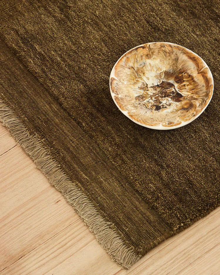 Silvio oakmoss rug detail view, showing micro fringe border and natural texture of hand-woven sustainable styling by Weave Home