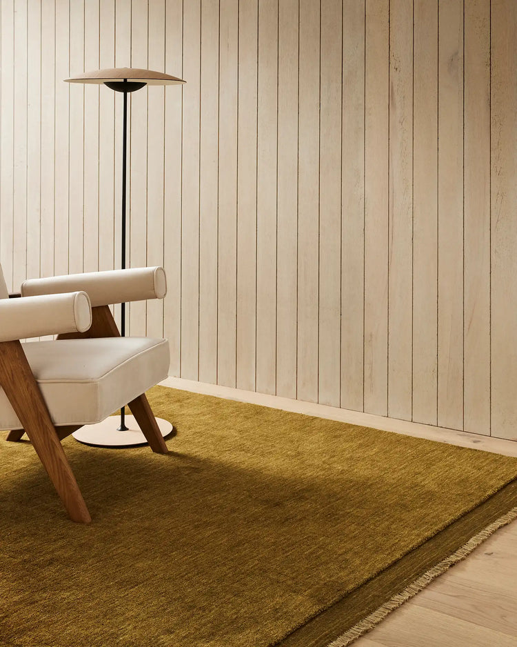 Silvio Oakmoss rug in rich olive, hand-woven with micro fringe border detail, styled in living room by Weave Home