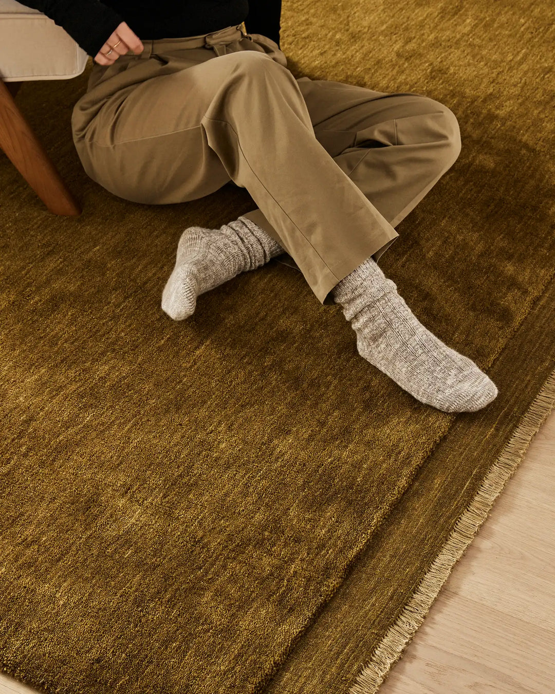 Silvio Oakmoss hand-woven rug detail, rich olive texture with micro fringe border and sophisticated edge finishing by Weave Home