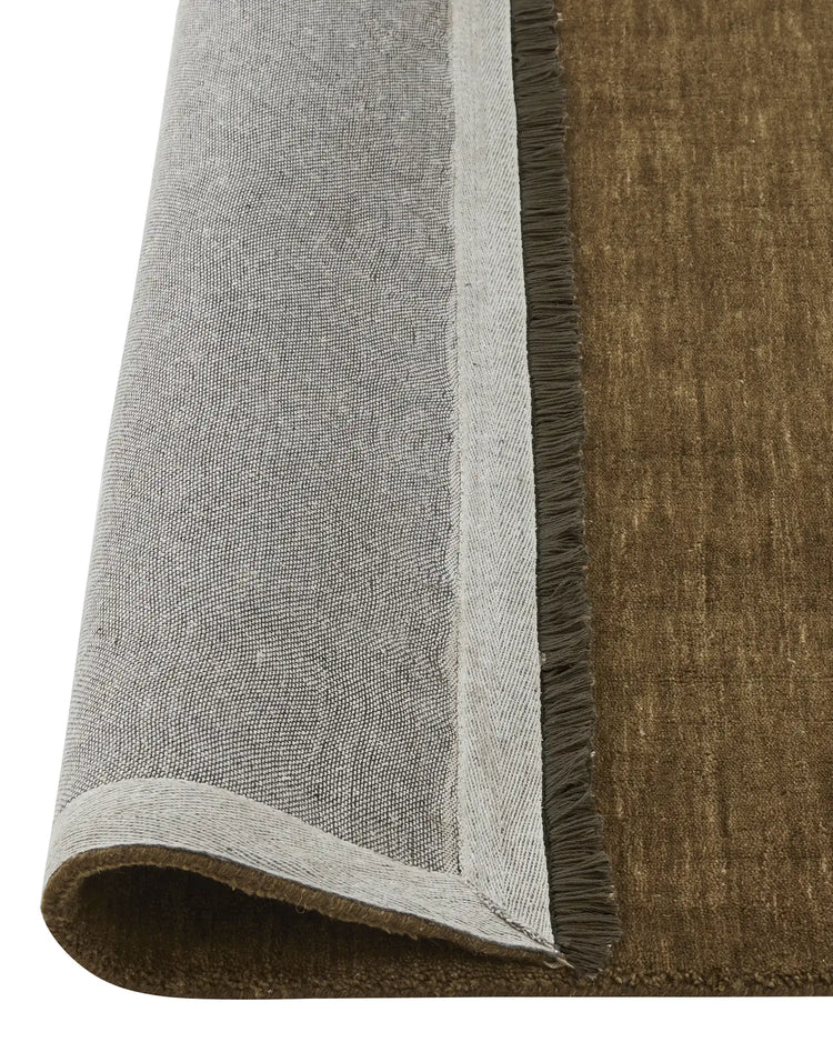 Silvio Oakmoss rug detail showing micro fringe border and textured weave, sustainable styling high-traffic rug by Weave Home