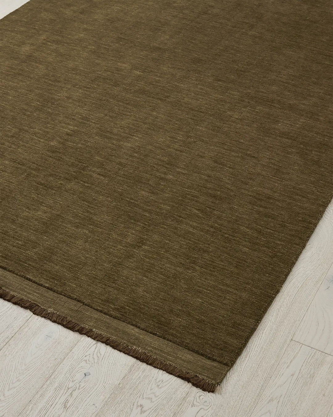 Silvio rug in Oakmoss, 3m x 4m, hand-woven wool with micro fringe border detail by Weave Home