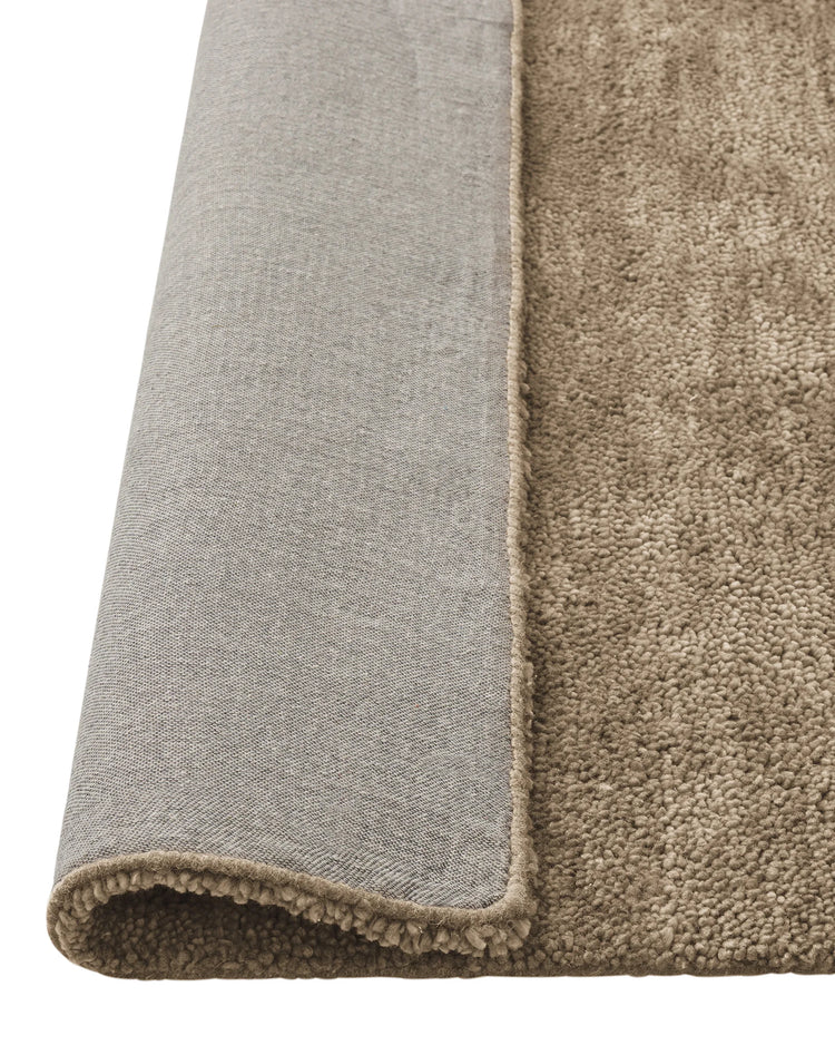 Valencia Latte rug in rich creamy beige, detail of plush chunky wool weave and binding edge, by Weave Home