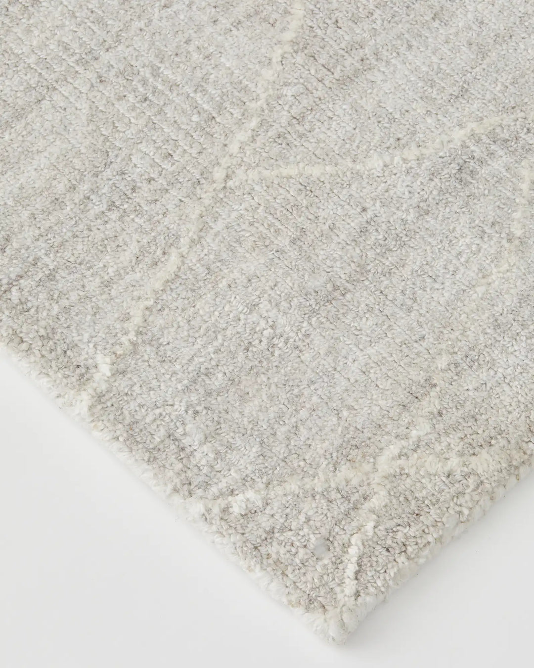 Katari Moon rug detail view showcasing textured diamond weave pattern in soft white and grey viscose blend by Weave Home