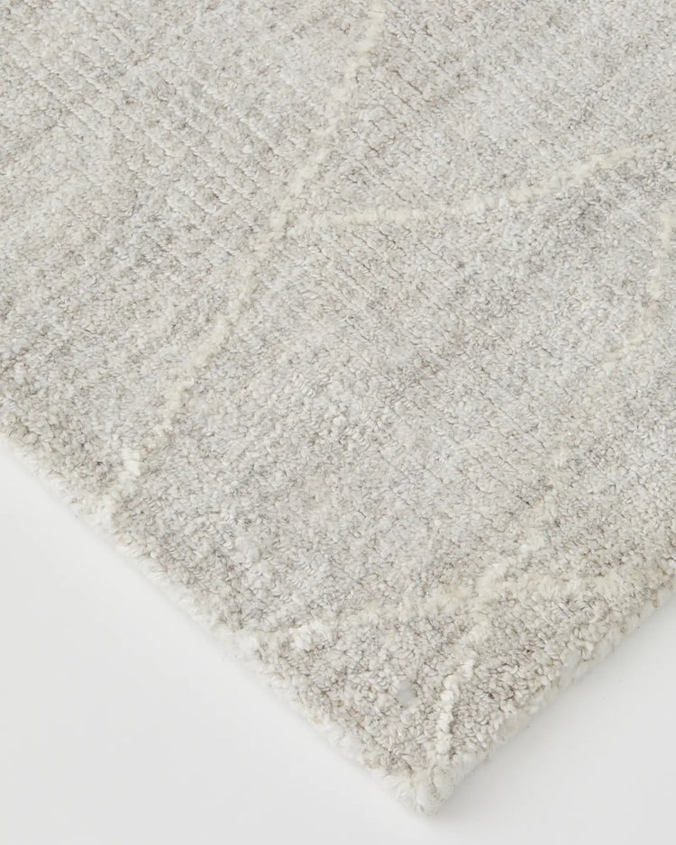 Katari Moon rug detail view showcasing textured diamond weave pattern in soft white and grey viscose blend by Weave Home