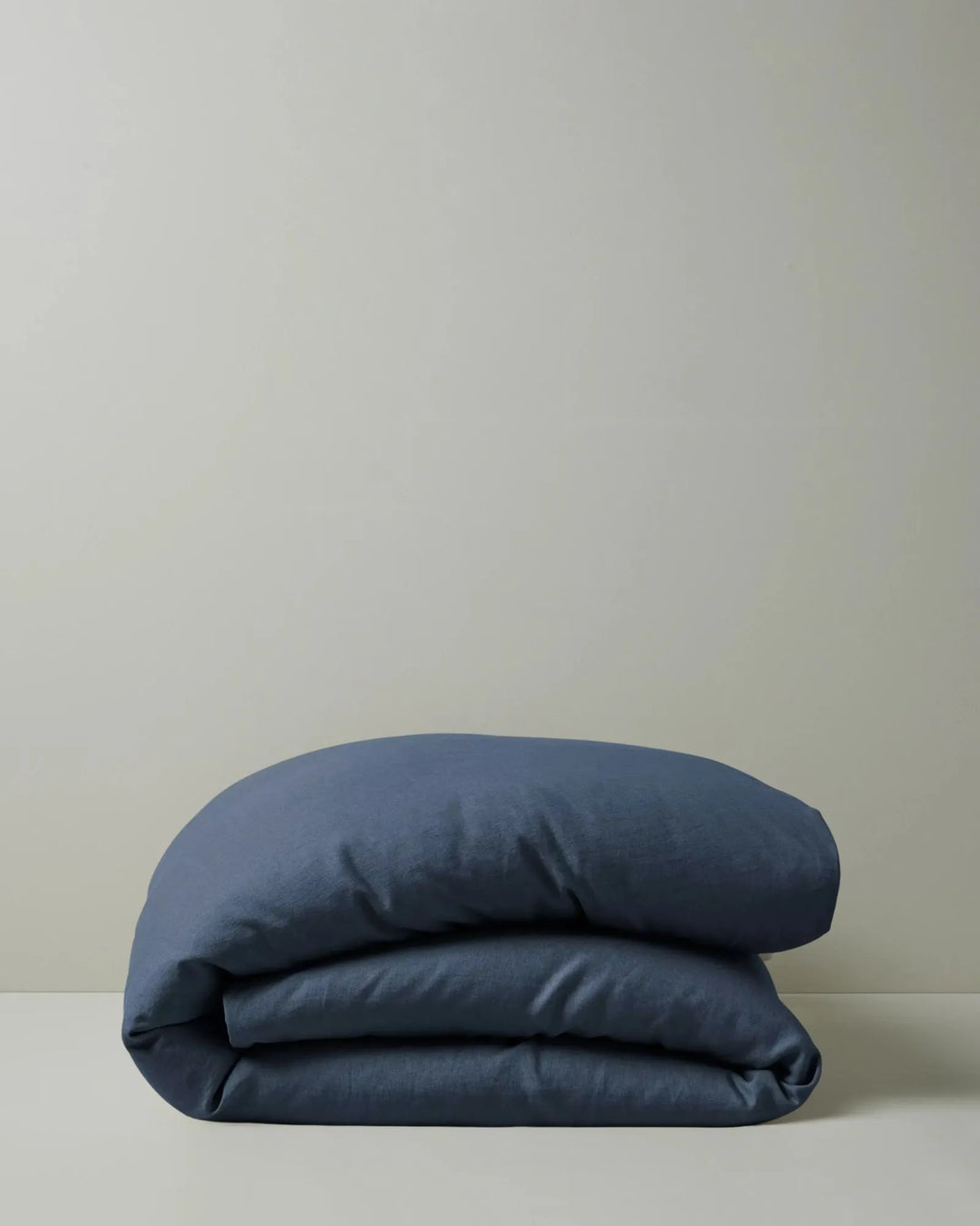 Ravello Quilt Cover in denim blue European linen, folded to show soft texture and relaxed drape, by Weave Home
