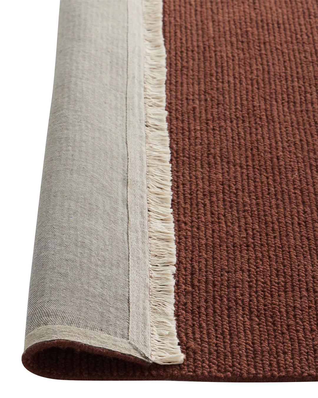 Fabien Ember rug detail shot showing ribbed wool weave texture with natural fringe edge and linen backing by Weave Home