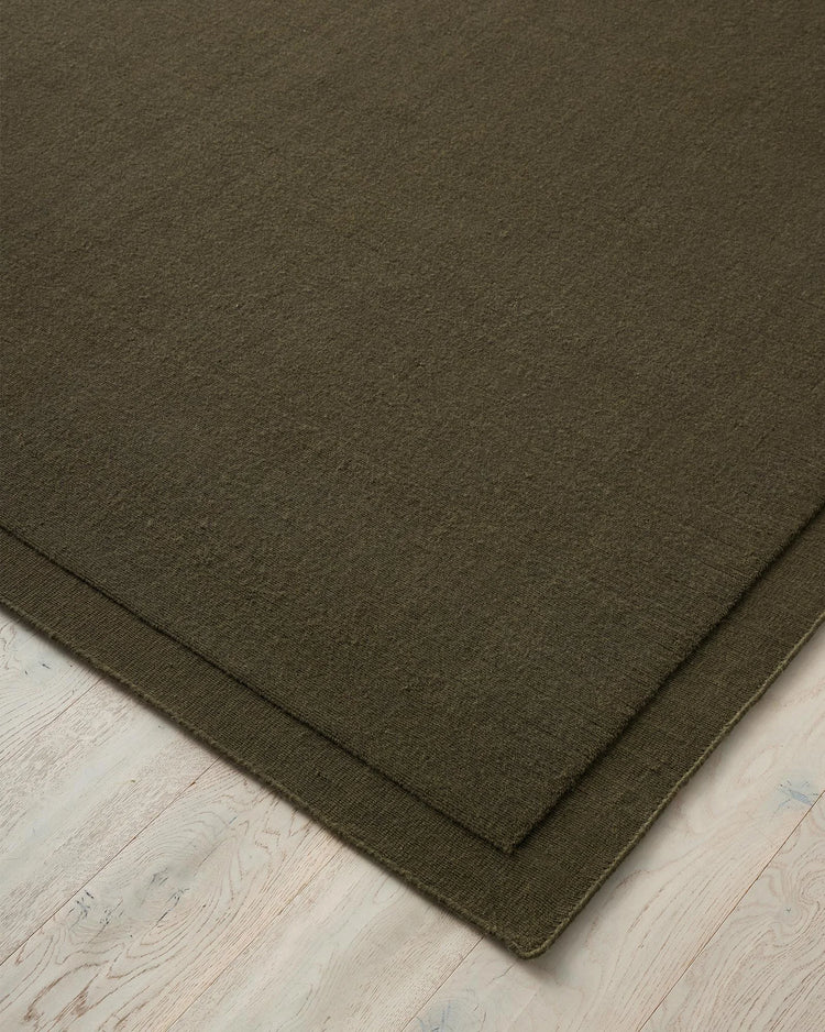 Cassio Jasper rug in deep olive, NZ wool loop pile with serged edge detail by Weave Home