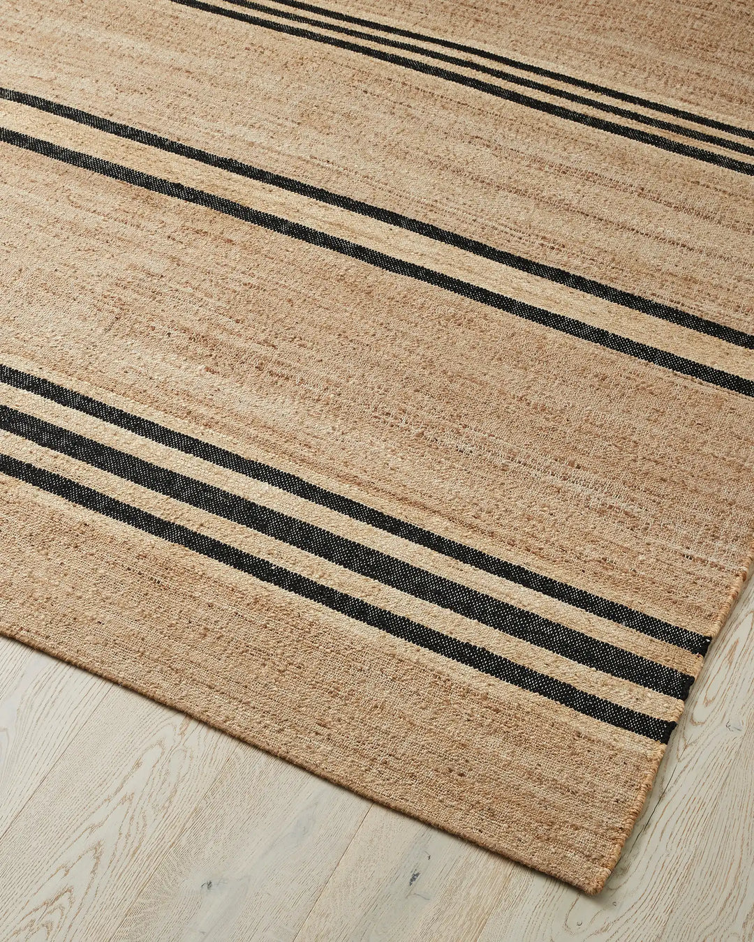 Umbra Natural jute rug with black stripe detail, flat weave high-traffic design by Weave Home
