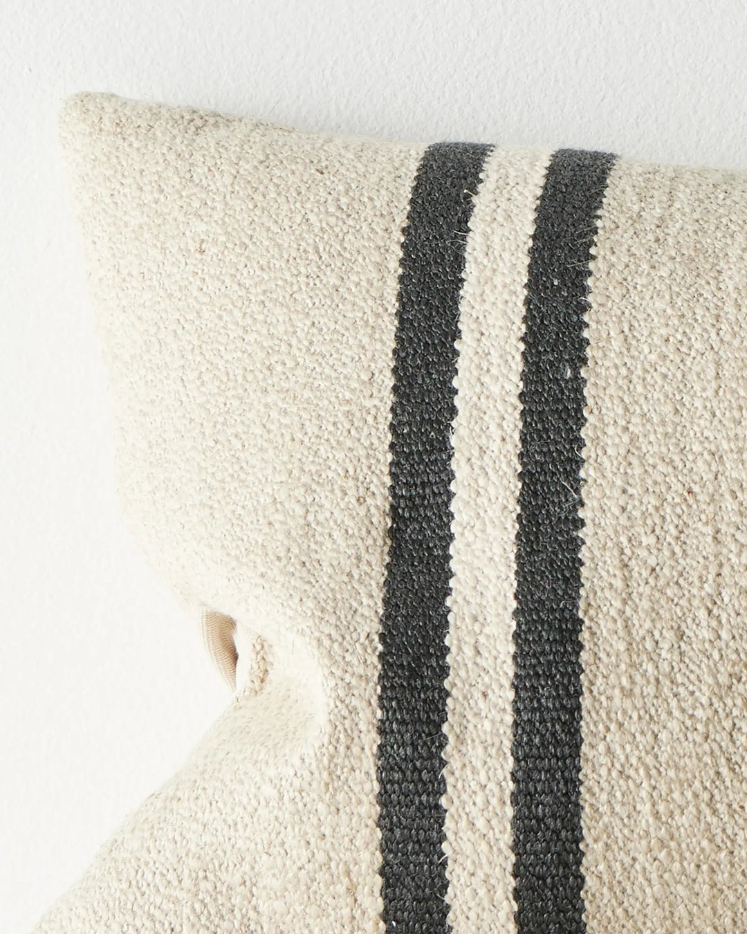 Mila Oyster lumbar cushion close-up, showing textured wool linen blend fabric with charcoal and cream striped detail by Weave Home