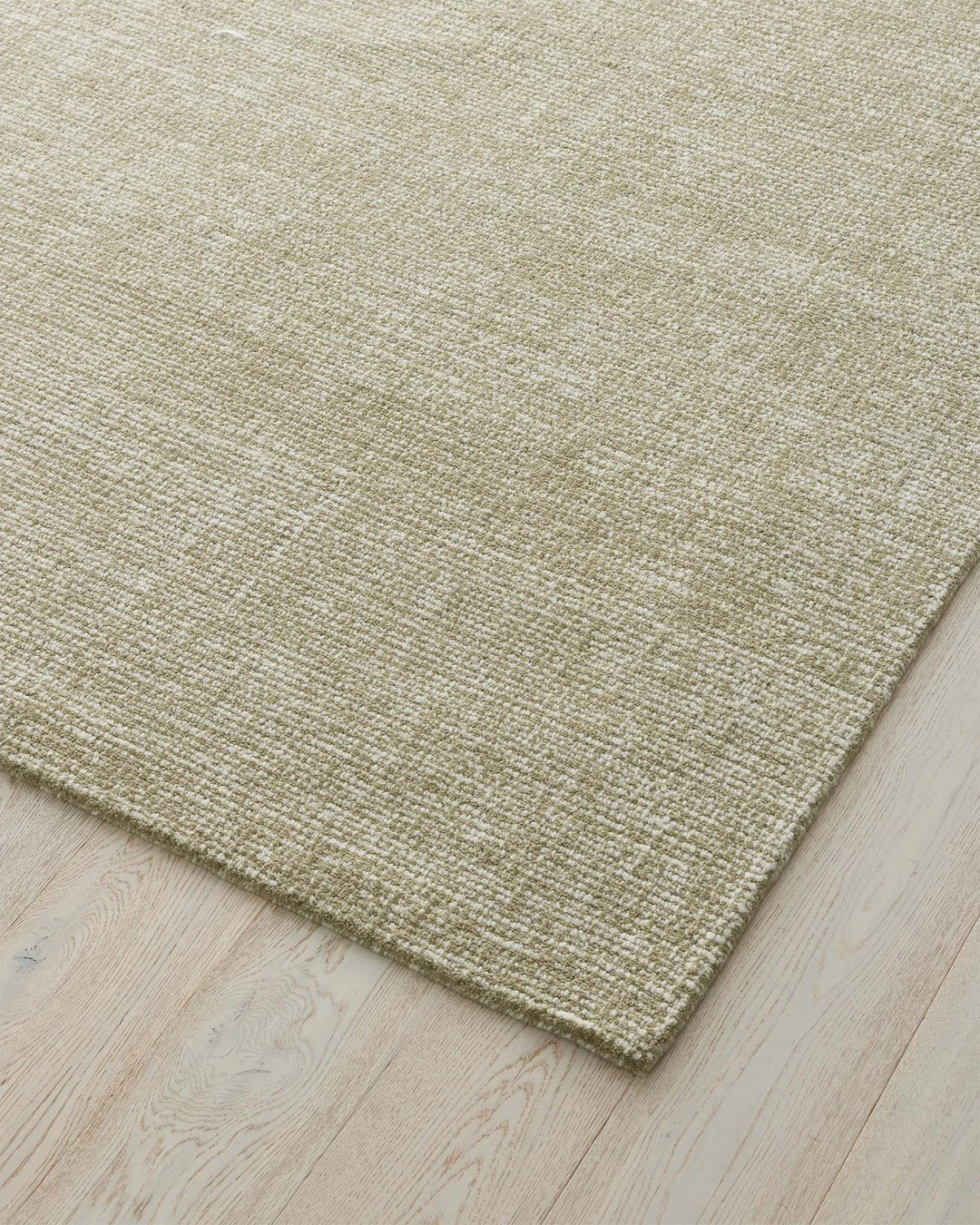 Kaia Willow rug in natural green, textured loop pile weave detail showing two-tone effect, 200x300cm NZ wool by Weave Home