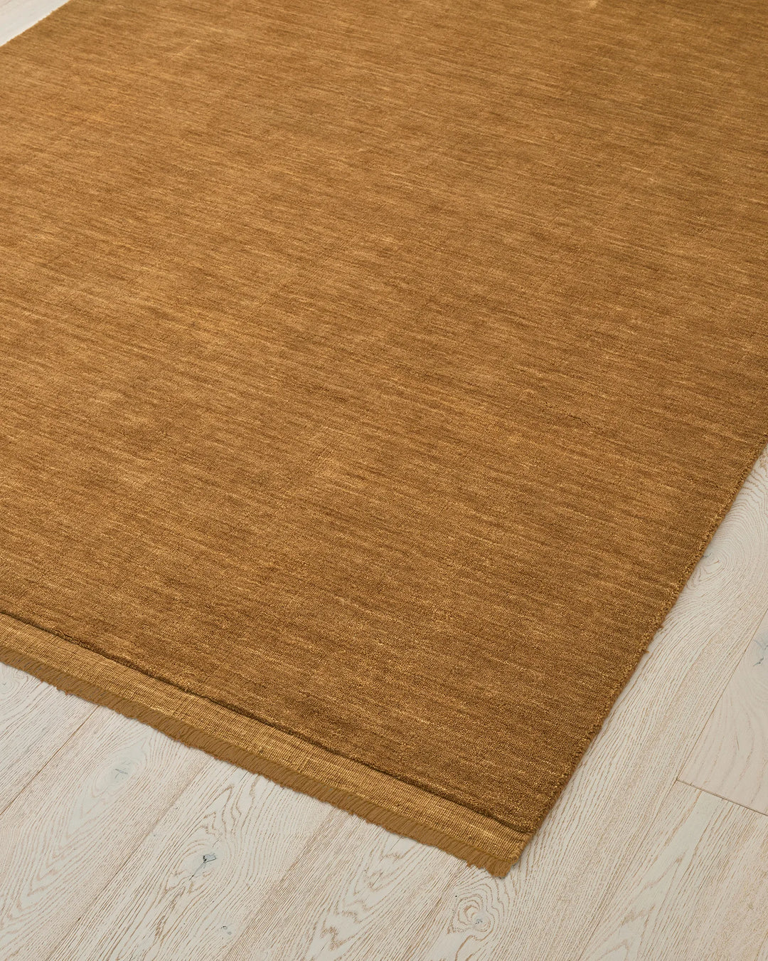 Silvio Dijon rug in mustard yellow, 3m x 4m, close-up corner detail showing micro fringe border and hand-woven texture by Weave Home