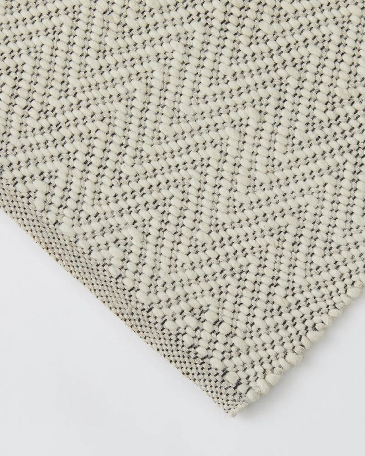 Matterhorn Seasalt rug detail, showing chevron weave pattern in cream wool-cotton blend with cotton braided edge by Weave Home