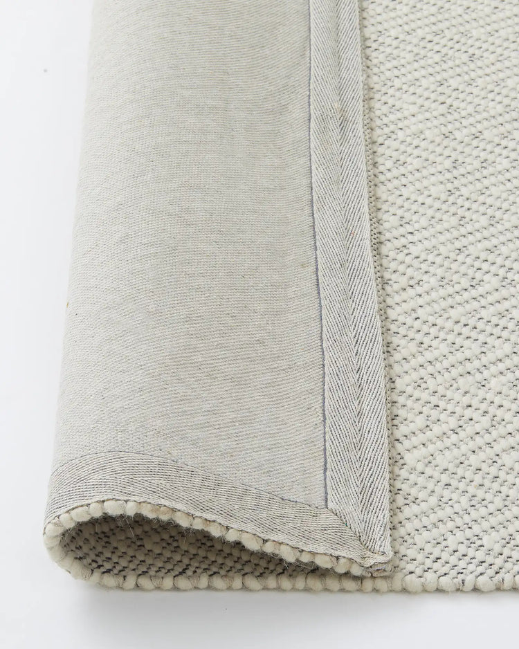 Matterhorn Seasalt rug detail shot showing wool cotton blend backing and cotton braided edge by Weave Home