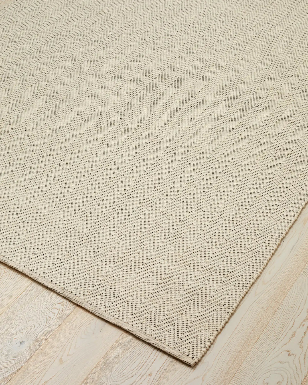 Matterhorn Seasalt 2m x 3m wool-cotton blend rug with chevron weave pattern, corner detail showing braided cotton edge by Weave Home