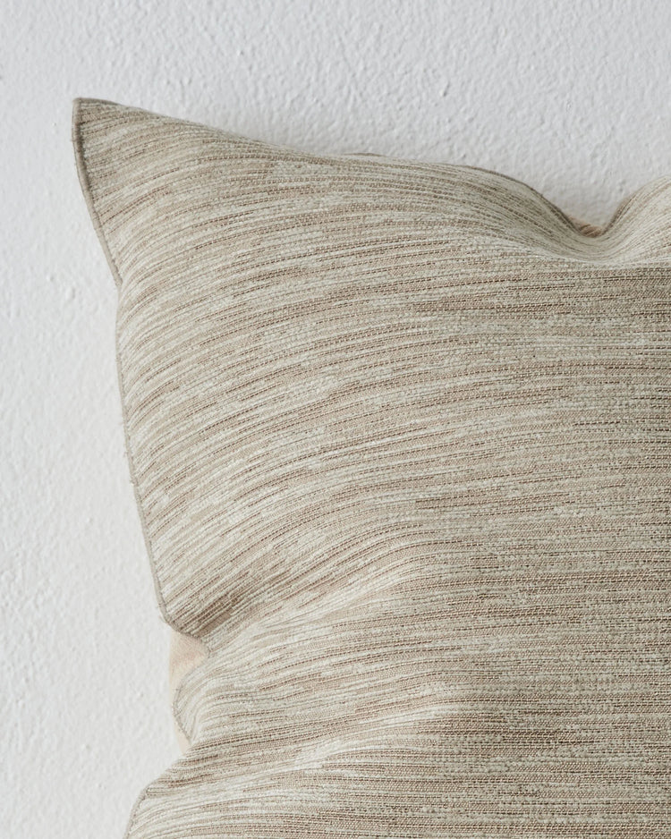 Dania Oyster cushion cover detail, showcasing woven texture and warm two-toned colourway with metallic highlights, by Weave Home