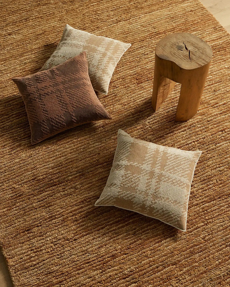 Sienne Earth cushion in reddish-brown polyester cotton blend with oversized check design, overlocked edge detail, on natural jute rug by Weave Home