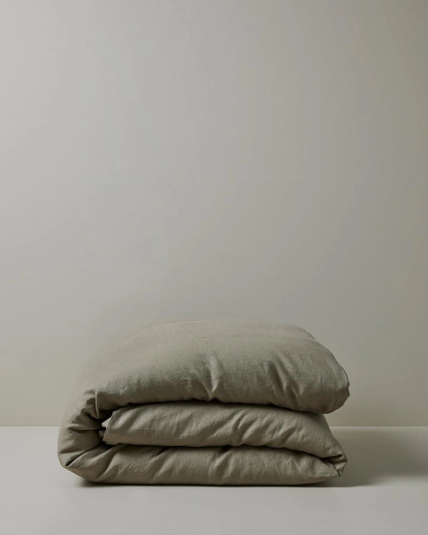 Ravello Quilt Cover in Caper, folded stack showcasing soft European linen weave and relaxed texture by Weave Home