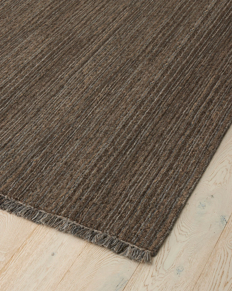 Puglia Fossil rug corner detail showing chunky woven texture in muted brown and grey tones with fringe edge by Weave Home