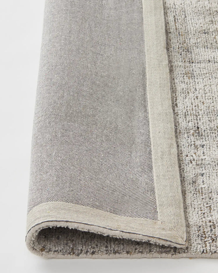 Matisse Shale rug detail showing cotton braided edge and backing, viscose blend low-traffic rug by Weave Home