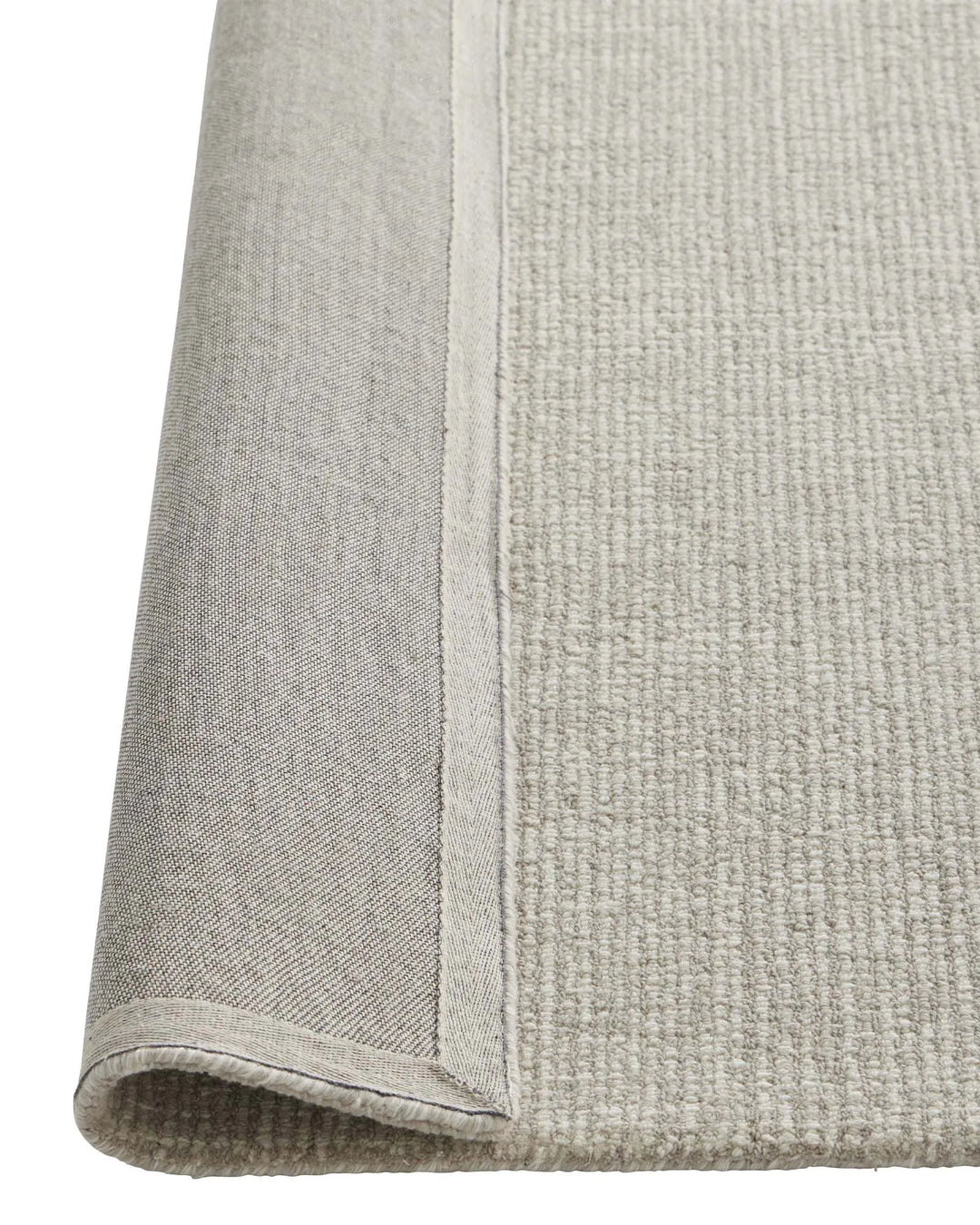 Kaia Mist rug detail view showing contrast loop pile texture and bound edge in cool neutral NZ wool by Weave Home