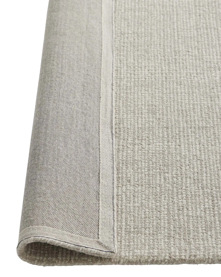 Kaia Mist rug detail view showing contrast loop pile texture and bound edge in cool neutral NZ wool by Weave Home