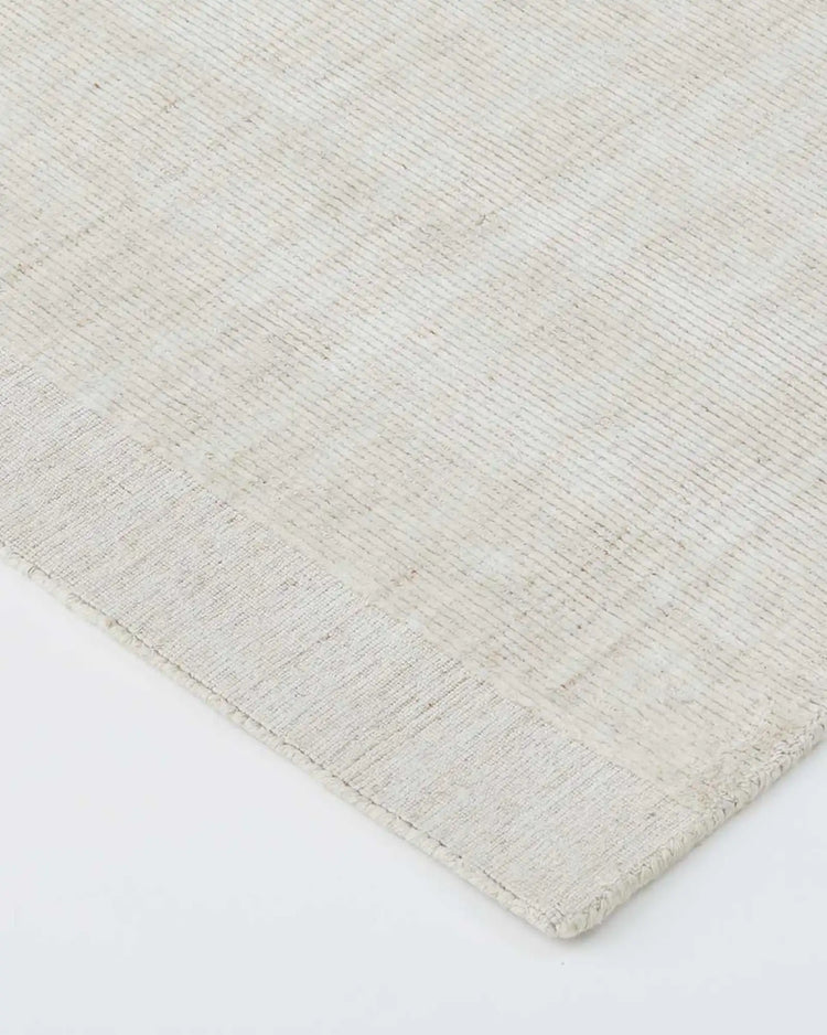 Travertine Buff low-traffic rug detail view, showing hand-woven viscose blend texture with marbled appearance and finished cotton edge by Weave Home