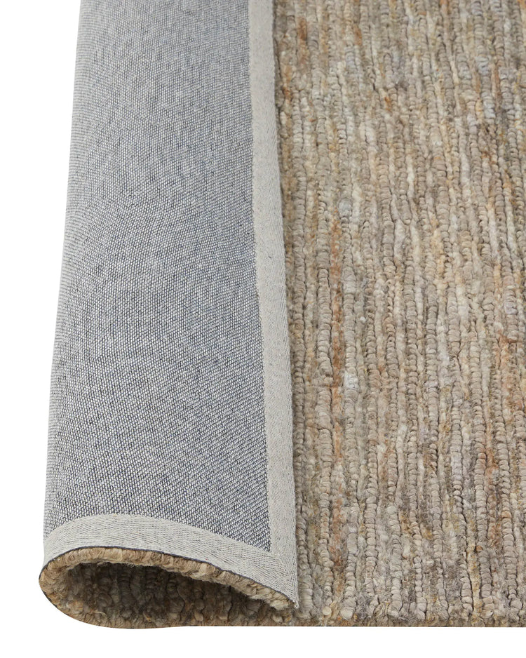 Bastian Fossil rug detail showing textured looped and cut jute weave in brown and cream tones by Weave Home
