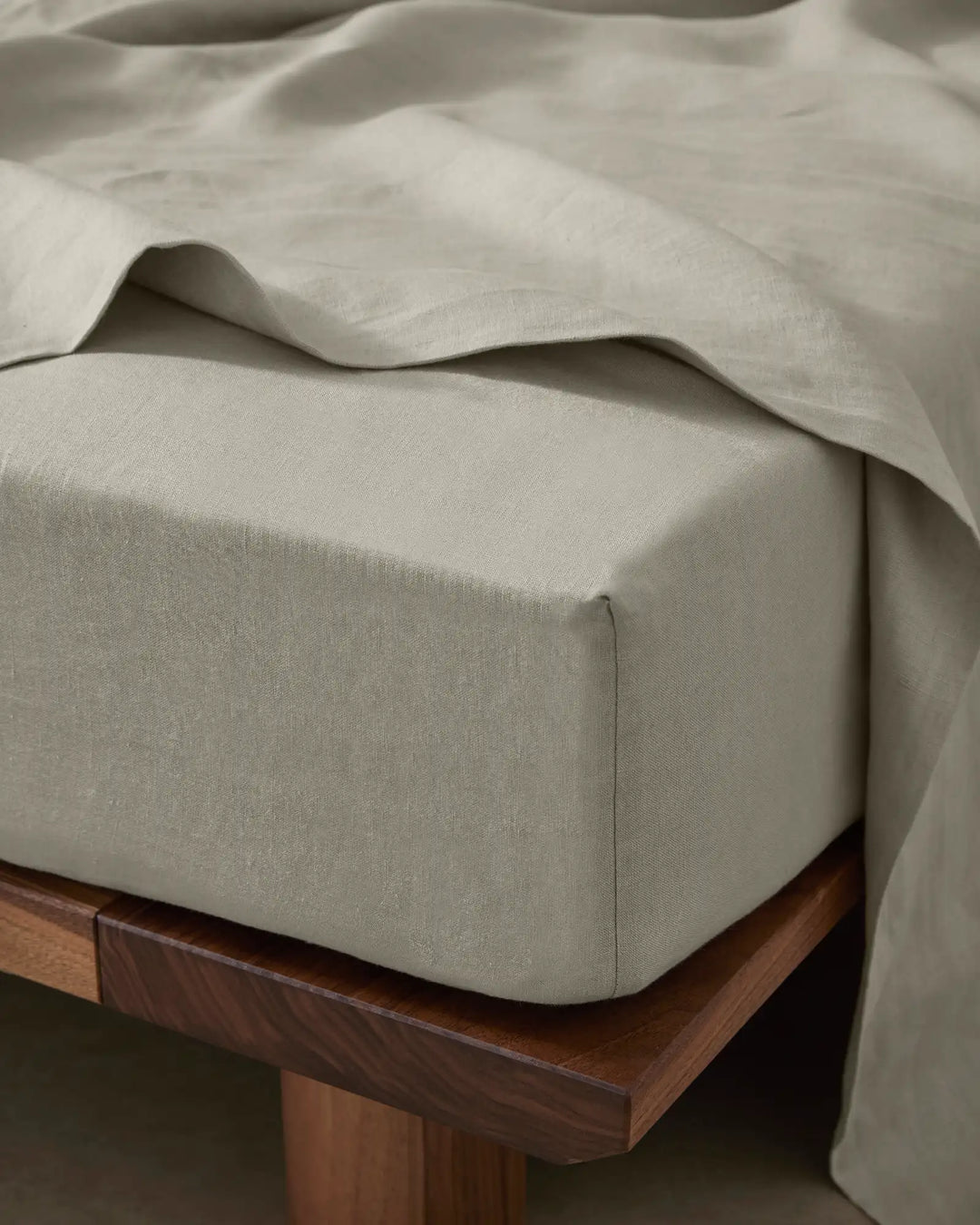 Ravello Fitted Sheet in Bone, European linen with extra thick banding detail, styled on wooden bed frame by Weave Home